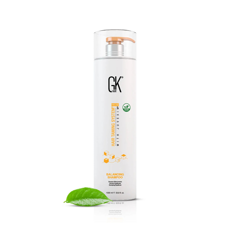 GK Hair Balancing Shampoo 1000 ml white bottle with orange pump and vegan badge, green leaf at its base, on white