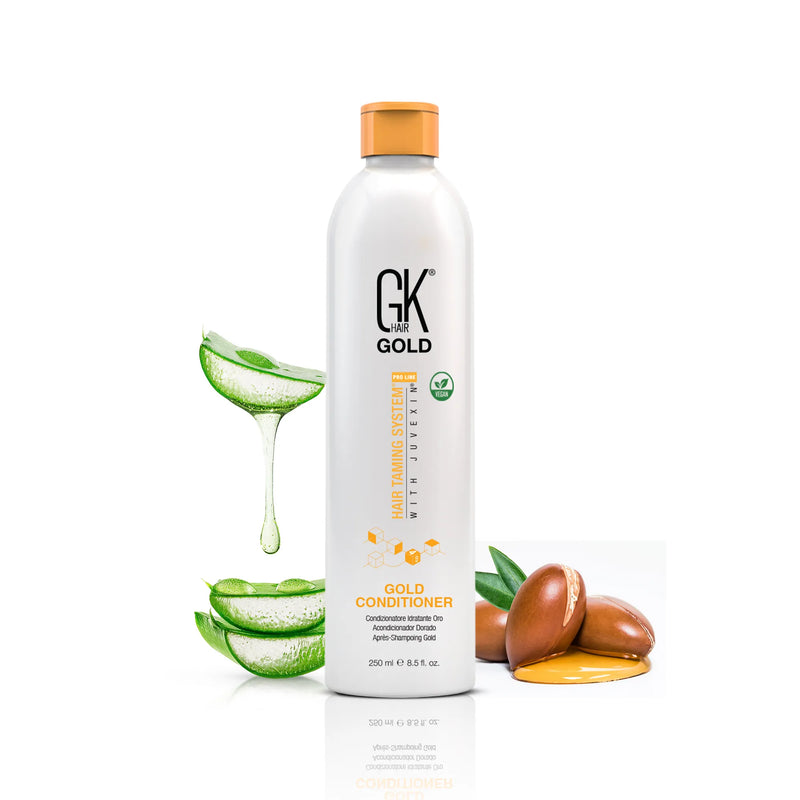 GK Hair Gold Conditioner 250 ml white bottle with orange cap between aloe vera slices and argan nuts with oil