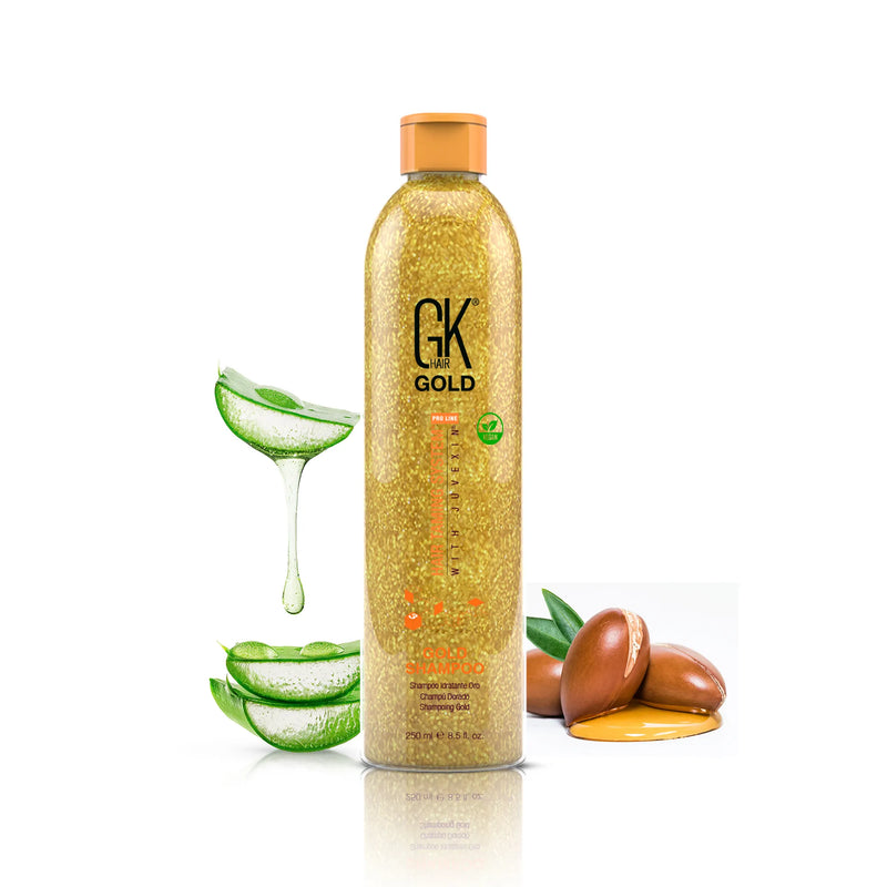 GK Hair Gold Shampoo 250 ml gold glitter bottle with orange cap between aloe vera slices and argan nuts with oil