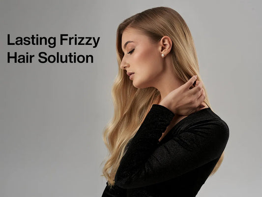 A woman with long, wavy hair dressed in a black top poses gracefully against a neutral background, promoting a frizz-control product.