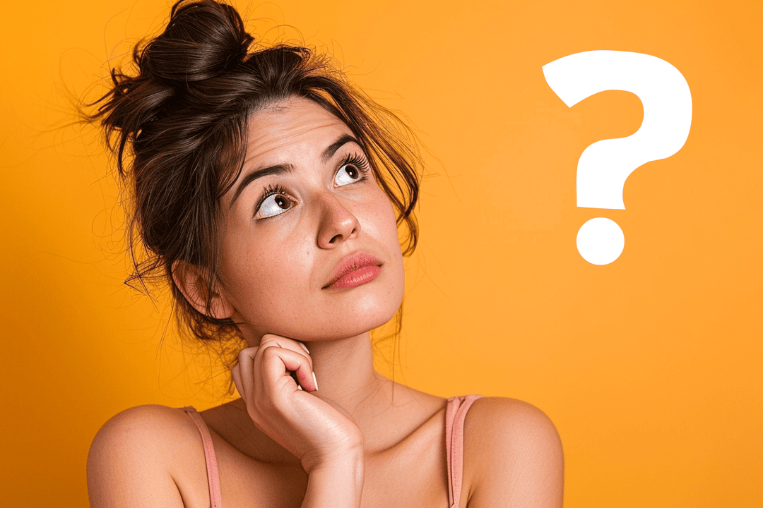 A woman with dark hair styled in a messy bun poses thoughtfully against a bright orange background, accompanied by a large white question mark.