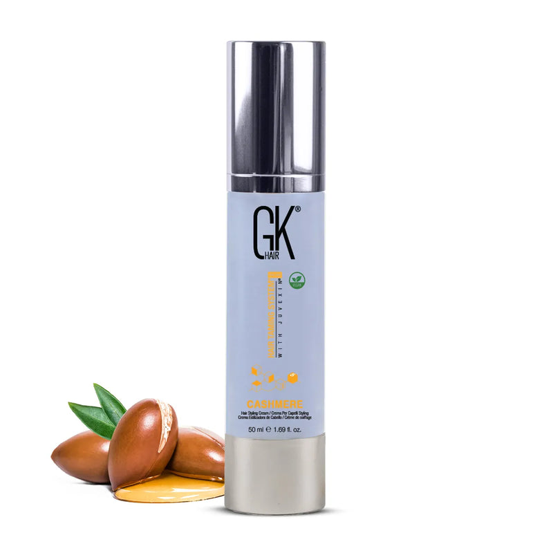 GK Hair Cashmere Hair Styling Cream 50 ml pale blue pump bottle beside argan nuts and oil, on a white background