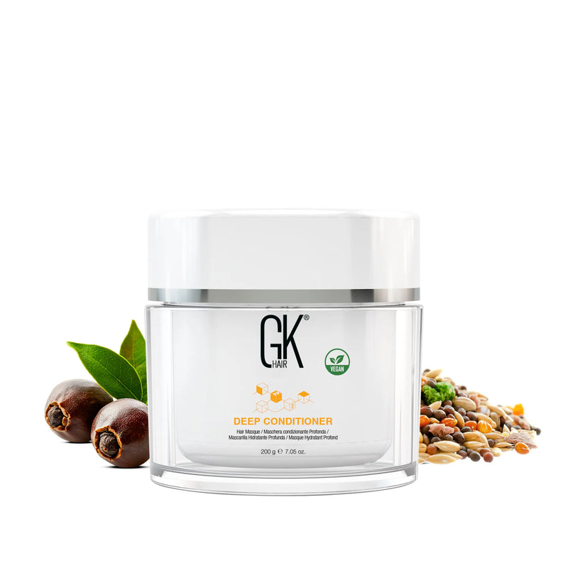 GK Hair Deep Conditioner 200 g clear jar with vegan badge on white, flanked by jojoba nuts, green leaves and mixed grains