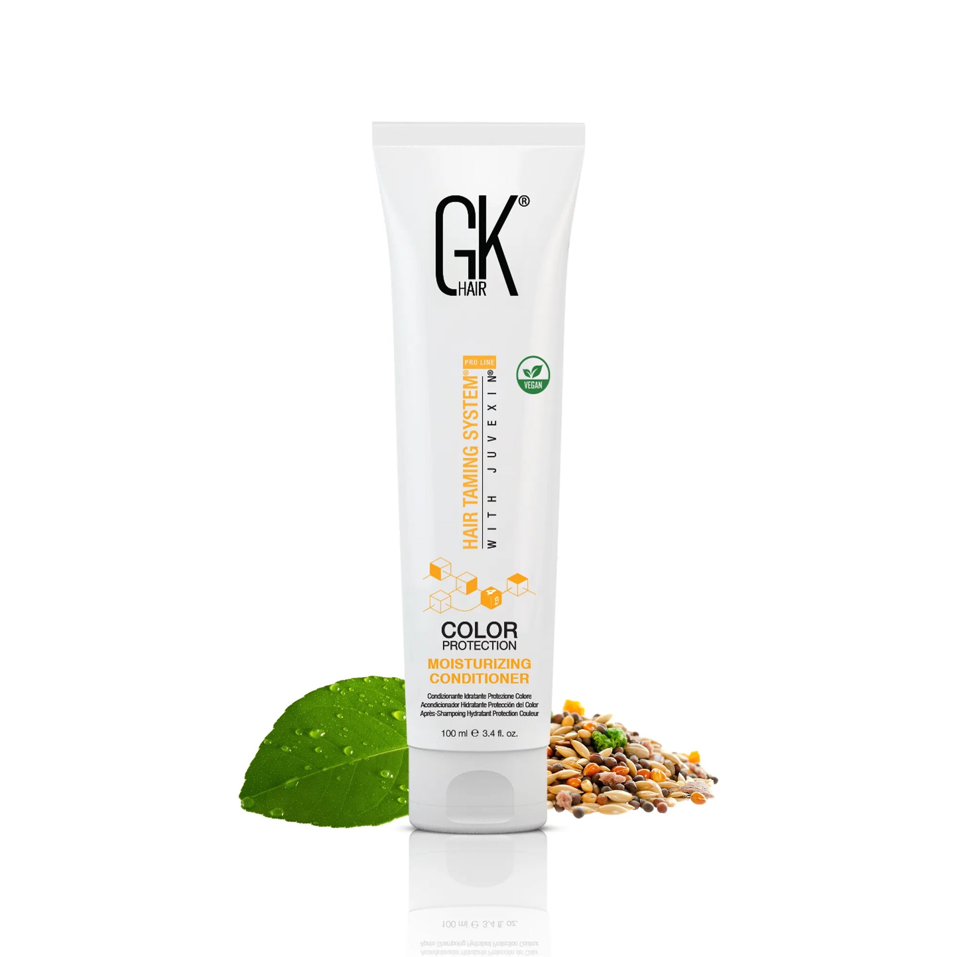 GK Hair Moisturizing Conditioner 100ml is centered. Surrounding it are a green leaf and seeds, emphasizing natural ingredients in a white background.