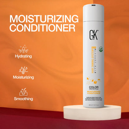 A white bottle of GK Hair Moisturizing Conditioner stands on a circular platform against an orange backdrop. Keywords: hydrating, moisturizing, smoothing.