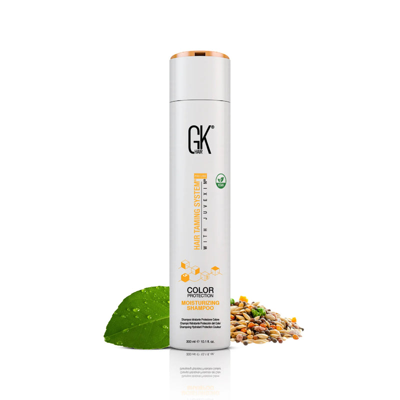 GK Hair Color Protection Moisturizing Shampoo 300 ml white bottle with rose gold cap beside a green leaf and seeds on white