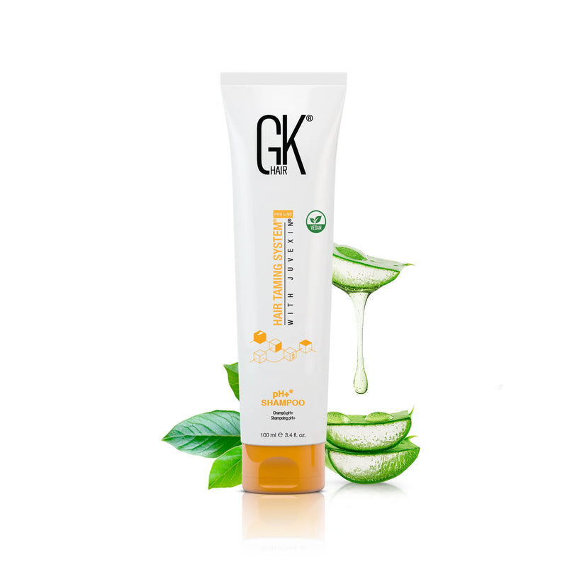 GK Hair pH+ Shampoo 100 ml white tube with orange cap and vegan badge beside dripping aloe vera gel and green leaves
