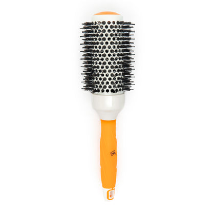 GK Hair thermal round brush standing upright, white ceramic barrel with black bristles and a ridged orange grip